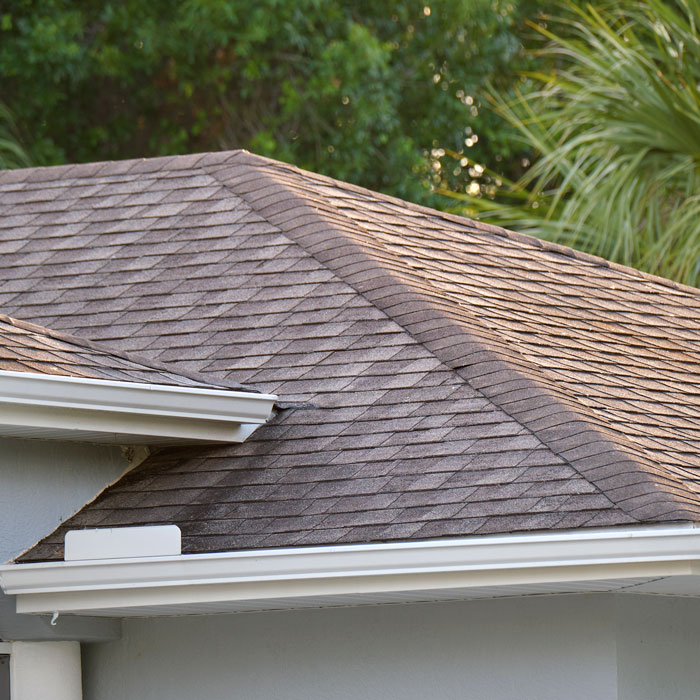 Closeup of house roof top covered with asphalt or bitumen shingles