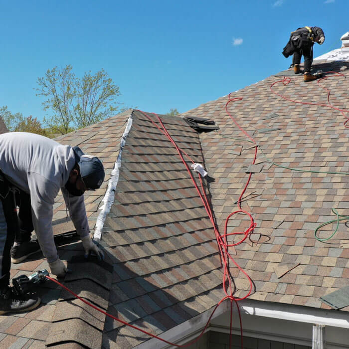 technicians installing a residential roof