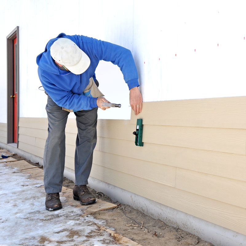 man installing siding